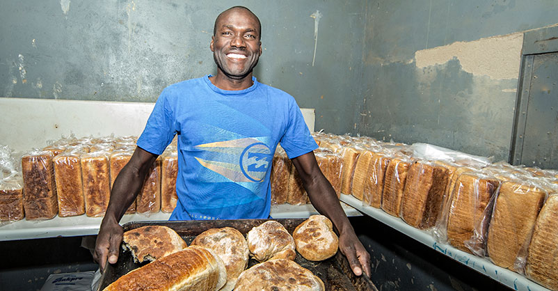 Malian man making bread
